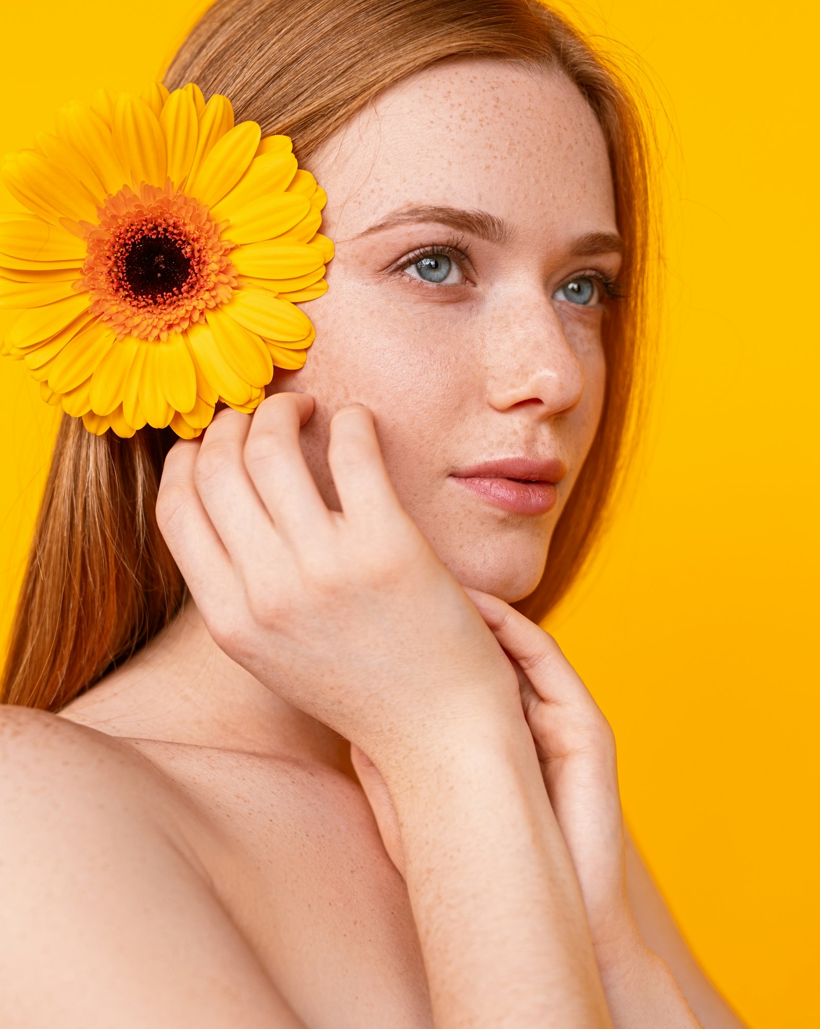 Redhead female with flower in hair